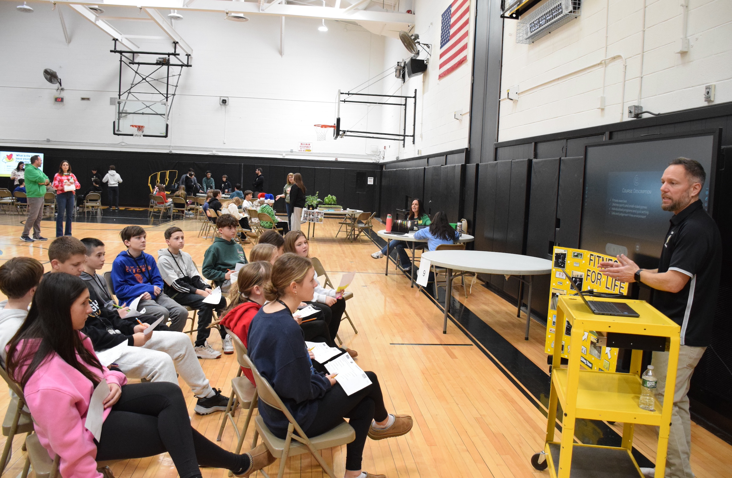 people sitting listening to man speak